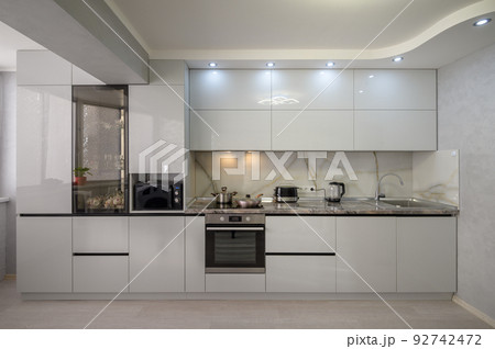 Interior of modern trendy white kitchen, front view 92742472