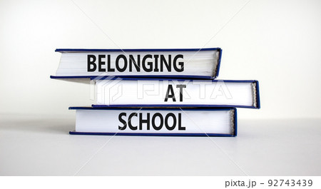 Belonging at school symbol. Books with words 'Belonging at school' on beautiful white background. Business, belonging at school concept. Copy space. Belonging at school symbol. Books with words 'Belonging at school' on beautiful white background. Business, belonging at school concept. Copy space. 92743439