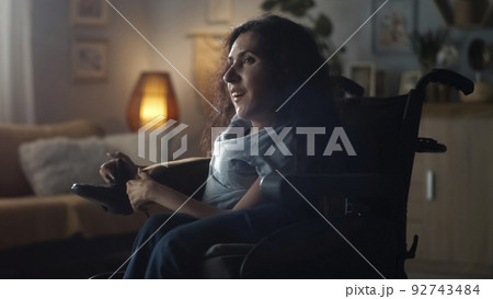 Happy woman in a modern wheelchair Happy woman in a modern wheelchair 92743484