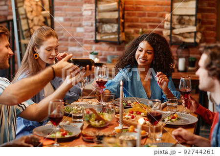Woman with Glass of Wine at Dinner Party Woman with Glass of Wine at Dinner Party 92744261