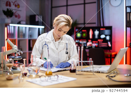 Female scientist working in laboratory. Female scientist working in laboratory. 92744594