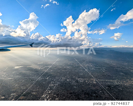 Clouds and sky as seen through window of an aircraft 92744837