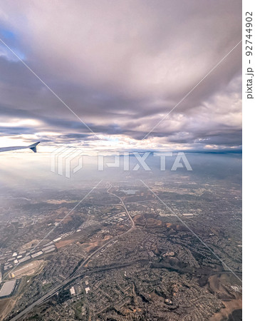 Clouds and sky as seen through window of an aircraft 92744902