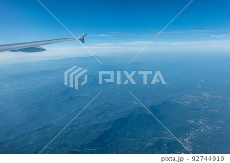 View of blue cloudy sky from airplane window 92744919