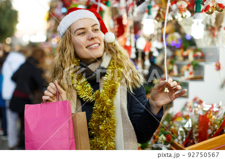 Cheerful girl at Christmas fair Cheerful girl at Christmas fair 92750567