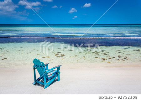 Idyllic beach with rustic adirondack chair in Aruba, Dutch Antilles 92752308