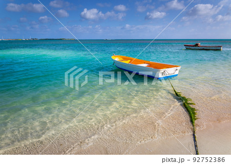 Idyllic beach with rustic wooden fishermen boat in Aruba, Dutch Antilles Idyllic beach with rustic wooden fishermen boat in Aruba, Dutch Antilles 92752386
