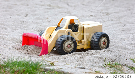 Dump truck toy working on the sand 92756538