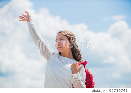Free education. Happy girl with school backpack sky background. Back to school. Little child smiling going to school. Knowledge day. Outdoors classes. Successful schoolgirl. Good day for studying Free education. Happy girl with school backpack sky background. Back to school. Little child smiling going to school. Knowledge day. Outdoors classes. Successful schoolgirl. Good day for studying 92756741