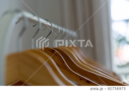 Close-up of wardrobe with wooden clothes hanger, Close-up of wardrobe with wooden clothes hanger, 92756973