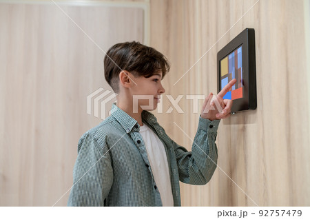 A boy touching screen of a sensor panel 92757479