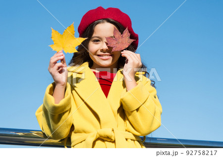 In love with nature. favorite season. good weather mood. parisian girl trendy look. school time. maple syrup. canada. happy small girl. autumn kid fashion. child maple leaf. leaf fall 92758217