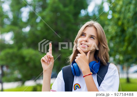 girl in white t-shirt with backpack going to school 92758488