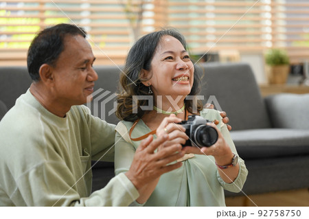 Joyful retired couple getting ready for travel vacation after quarantine. Traveling in retirement concept 92758750