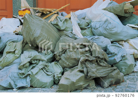 Construction garbage after building repair in bags. Removal of debris. Bunch of trash for utilize. 92760176