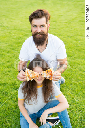 Teasing her with food. Fast food. Bearded man feeding Teasing her with food. Fast food. Bearded man feeding 92760608