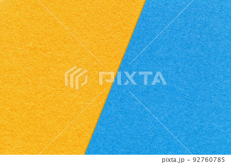 Texture of craft yellow and light blue paper background, half two colors, macro. Texture of craft yellow and light blue paper background, half two colors, macro. 92760785