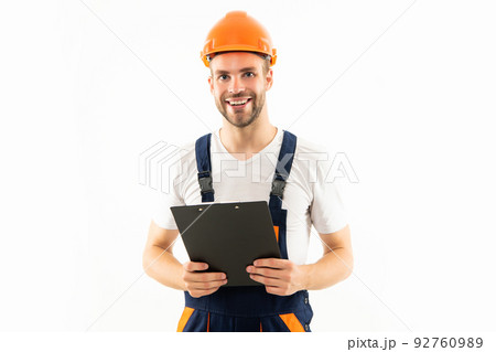 happy man in hardhat holding clipboard isolated on white background, builder 92760989