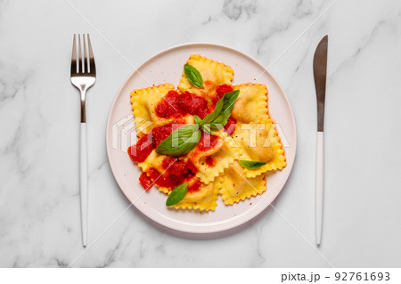 Delicious appetizing ravioli with tomato sauce and basil Delicious appetizing ravioli with tomato sauce and basil 92761693