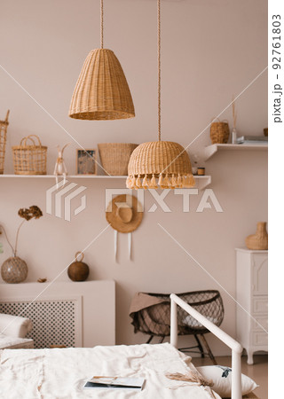 Traditional asian interior bedroom at cozy house with ethnic decor. Wicker lamps above the bed Traditional asian interior bedroom at cozy house with ethnic decor. Wicker lamps above the bed 92761803
