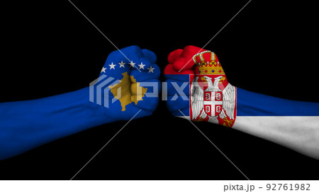 Serbia vs Republic of Kosovo. Two fists with national flags for military conflict. On black background Serbia vs Republic of Kosovo. Two fists with national flags for military conflict. On black background 92761982