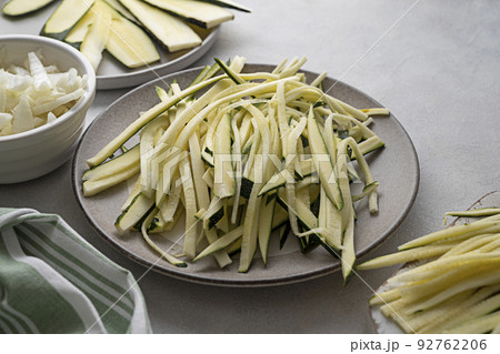 Zucchini, raw courget spaghetti pasta with cheese, clean eating, vegan food, low carb healthy food Zucchini, raw courget spaghetti pasta with cheese, clean eating, vegan food, low carb healthy food 92762206