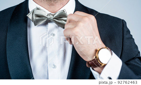 Perfect choice for elegant look. Male hand fix silver bow tie. Fashion accessory. Wedding and prom party. Holiday celebration. Formal event. Festive occasion. Very classy and elegant 92762463