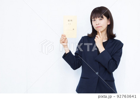 給料袋を持って悩む30代のビジネスウーマン 92763641