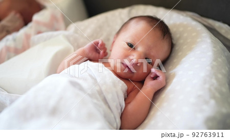 baby newborn. little baby a newborn 1 month of life lies in bed in the maternity hospital. happy family kid dream concept. close-up baby indoors. beautiful cute girl lies at lifestyle home 92763911