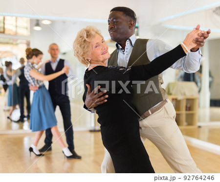 Elderly woman learning ballroom dancing in pair...の写真素材