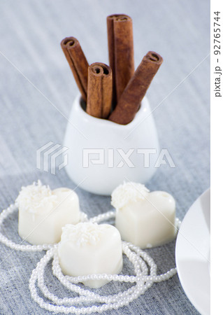 heart-shaped chocolates with candies in coconut flakes of beads heart-shaped chocolates with candies in coconut flakes of beads 92765744