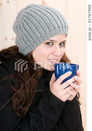 ery cold woman in a cabin in autumn or winter 92767866