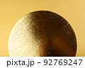 Golden circle on a yellow background. 92769247