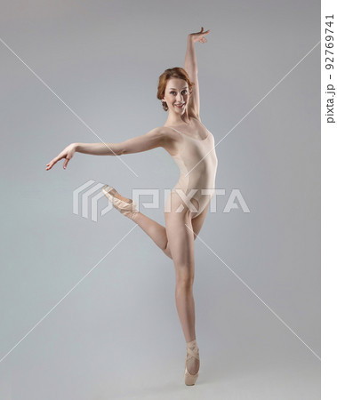 charming ballerina posing in the studio on a white background 92769741