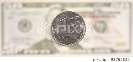 Russian ruble on the background of a blurred fifty dollars bill. Concept of currency exchange 92769830