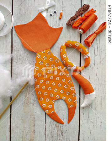 Process of stuffing soft toy red textile fox by handmade, top view and sewing accessories 92770824