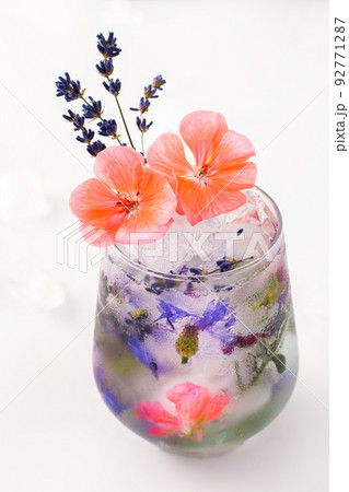 Cold drink with frozen flowers Cold drink with frozen flowers 92771287