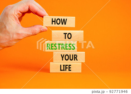 Restress your life symbol. Concept words How to restress your life on wooden blocks. Doctor hand. Beautiful orange background. Psychological business and restress your life concept. Copy space. 92771946