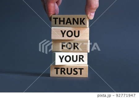 Thank you for trust symbol. Concept words Thank you for your trust on wooden blocks on a beautiful grey table grey background. Businessman hand. Business and thank you for trust concept. 92771947