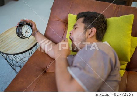 muslim man in the bed turning the alarm off muslim man in the bed turning the alarm off 92772555