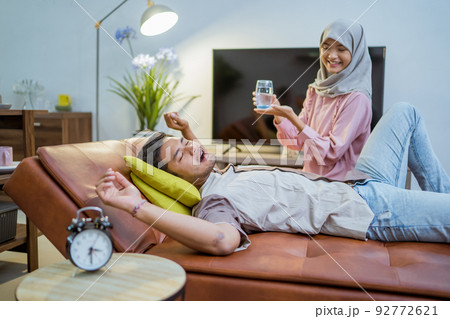 wife waking her husband up in the bed to have a breakfast wife waking her husband up in the bed to have a breakfast 92772621