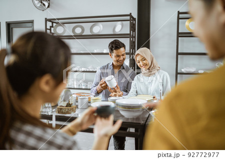 Candid photo shots of Muslim couple when choosing a cup Candid photo shots of Muslim couple when choosing a cup 92772977