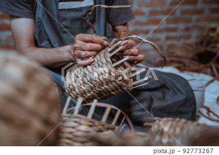close up of male entrepreneur hands weaving crafts 92773267