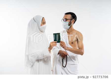 couple holding a passport together when look at each other couple holding a passport together when look at each other 92773706