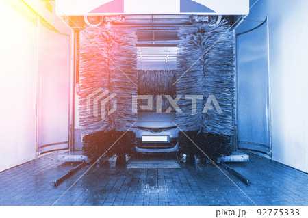 Car washing automatic carwash. Brush washer clean blue auto car on automatic car wash station. Carwash cleaning service. Car washing automatic carwash. Brush washer clean blue auto car on automatic car wash station. Carwash cleaning service. 92775333