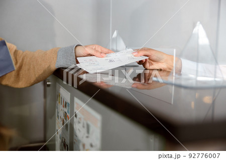 Close up of airport check-in counters with passengers 92776007