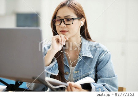 Young woman study in front of the laptop computer at home. Young woman study in front of the laptop computer at home. 92777252