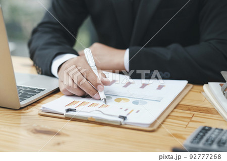 Close up of businessman analyse investment marketing data. 92777268