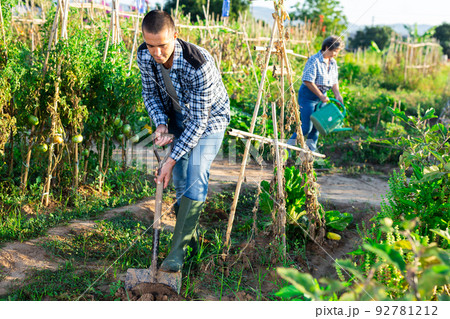 Positive man professional horticulturist with garden shovel at land 92781212