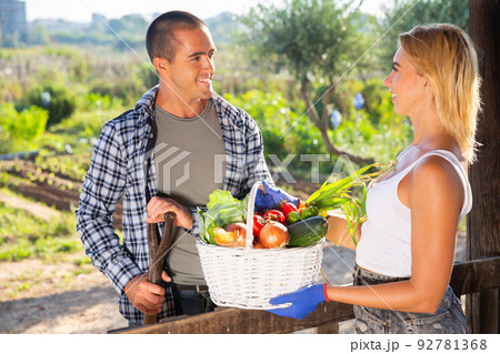 Happy couple proud of harvest of vegetables Happy couple proud of harvest of vegetables 92781368